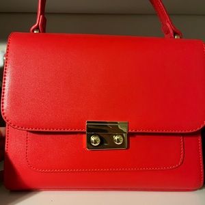 New red top handle bag with long strap
